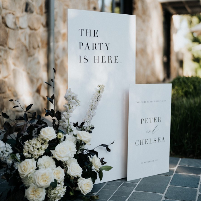 The Party Is Here freestanding welcome sign duo