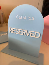 Load image into Gallery viewer, Blue acrylic RESERVED table sign with raised white lettering